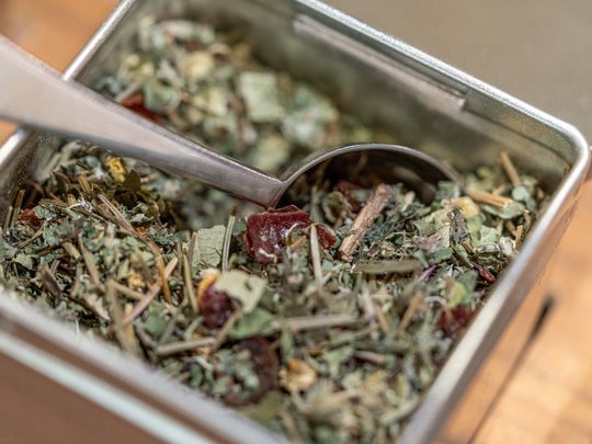 Morning indulgence in Vent: our accommodation with breakfast Metal tin with dried herbs and a teaspoon inside