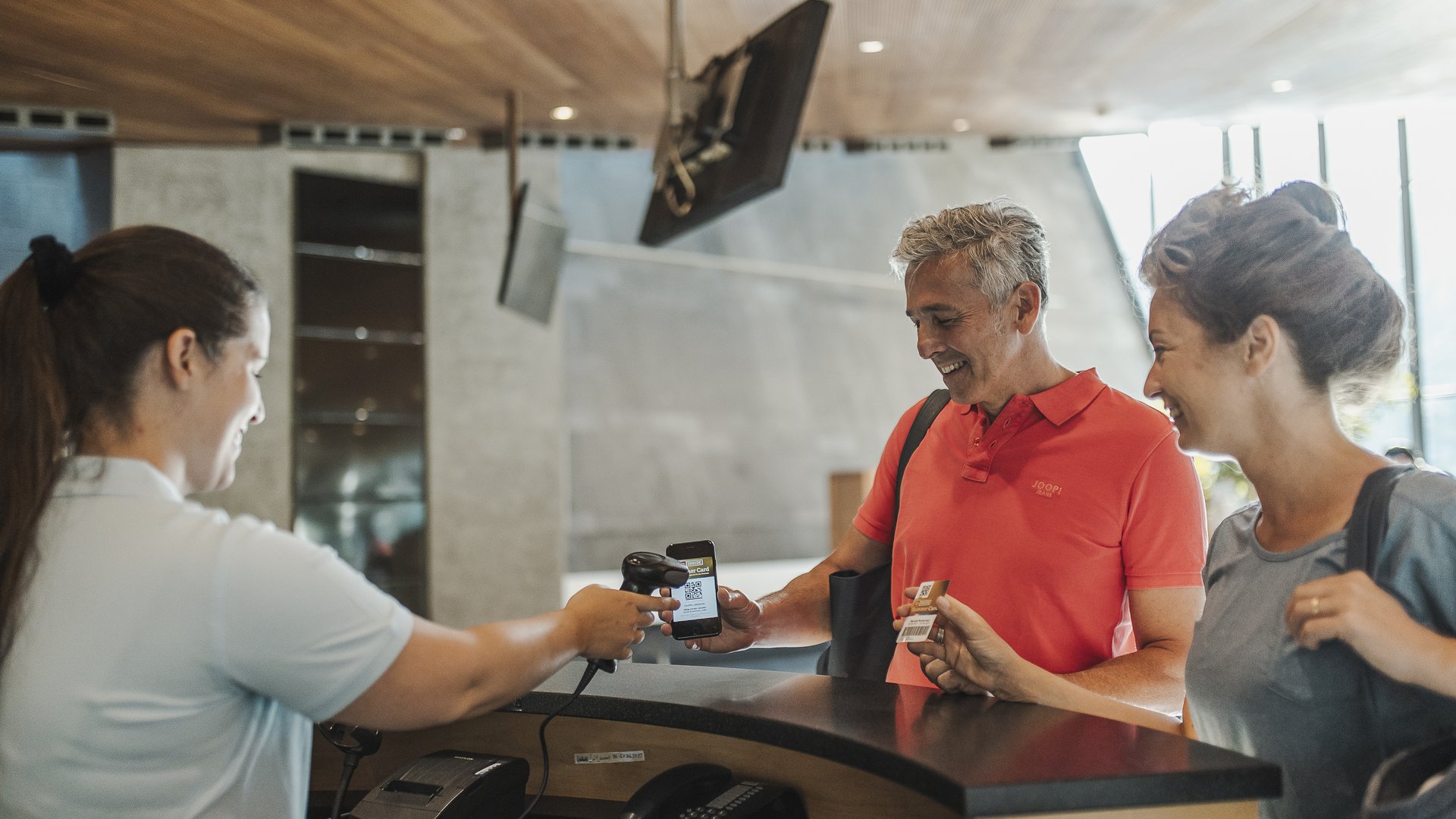 Ötztal Summer Card : découvrir l’Ötztal depuis votre hôtel Person montre un code QR sur smartphone à la réception