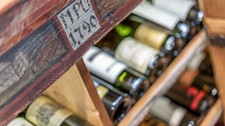 Pictures of our mountain hotel in Vent Wine bottles in an old wooden labeled wine rack