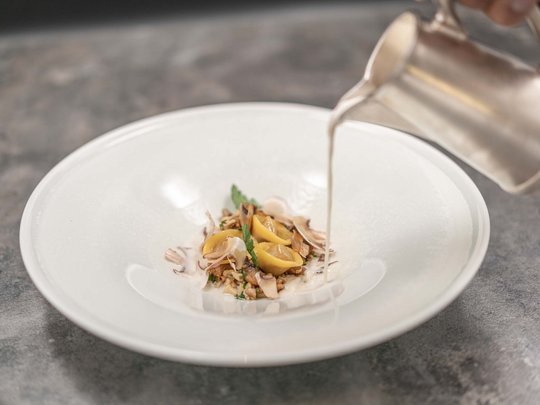 The heights of indulgence in Vent: our restaurant, Die Post Plate with tortellini and mushrooms, white sauce being poured