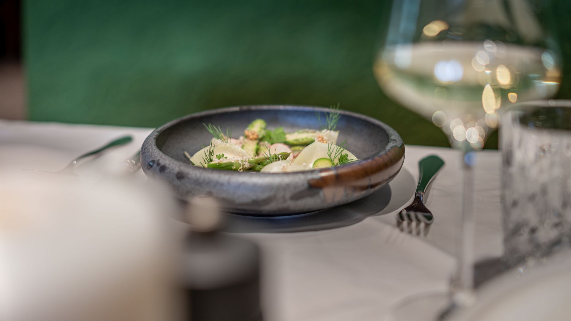 The heights of indulgence in Vent: our restaurant, Die Post Elegant salad plate on a set table with wine glass and cutlery