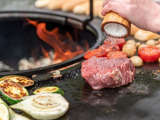 The heights of indulgence in Vent: our restaurant, Die Post Raw steak and vegetables on grill with hand sprinkling salt
