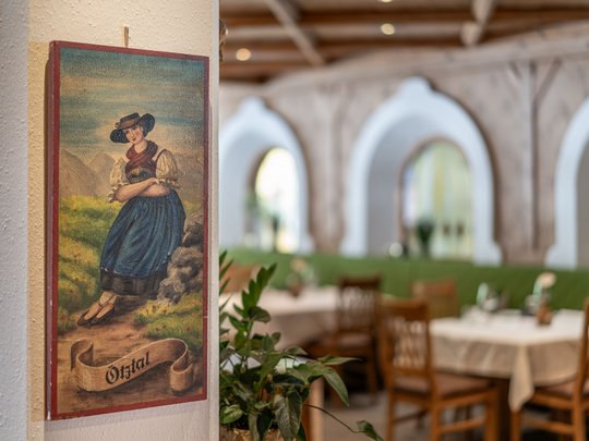 The heights of indulgence in Vent: our restaurant, Die Post Painting of woman in traditional dress in a restaurant with wooden furniture