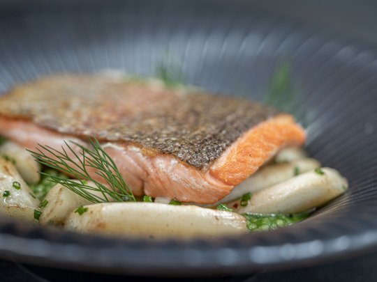 The heights of indulgence in Vent: our restaurant, Die Post Pan-seared salmon fillet with asparagus and dill on a black plate