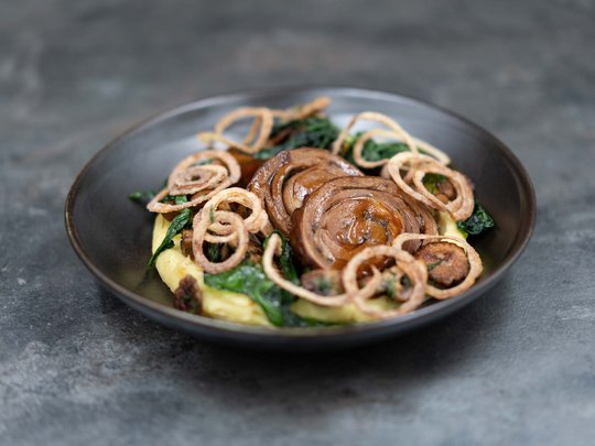 The heights of indulgence in Vent: our restaurant, Die Post Gourmet dish with braised mushrooms, spinach, crispy onion rings, and creamy mashed potatoes