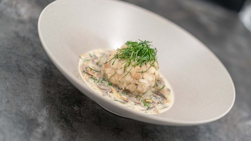 Your holiday in Vent: Enquire now with no obligation! Bread dumpling with creamy mushroom sauce and fresh herbs on white plate
